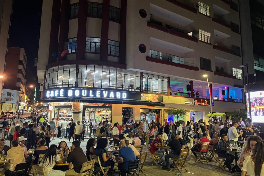 A bar on the promenade at night with music and salsa dancing in the street, Cali, Colombia