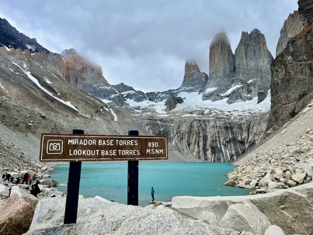 Torres base sign and clouds coming back in to cover torres, Torres del Paine, Chile